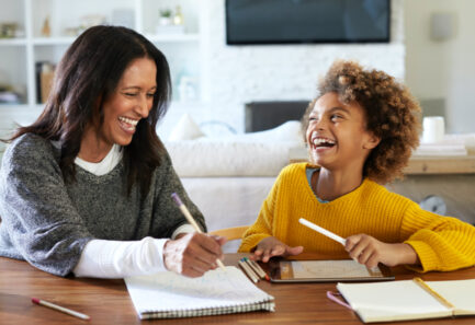Mother and daughter working on school work together 